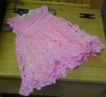 Pretty in pink!  Hand chrochetted dress.  size 18-24 months has a pink slip underneath and pink satin ribbons.  This dress is hand washable.  The price?  Only  $35.00.