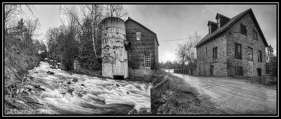 Bedford Mills This panoramic view of Bedford Mills was taken on a dark rainy day and I thought processing it in Black and White might be interesting.  The buildings date from 1848 and there was originally an older sawmill on the same site. The area was thriving but declined and the town of Bedford Mills is now considered a ghost town.